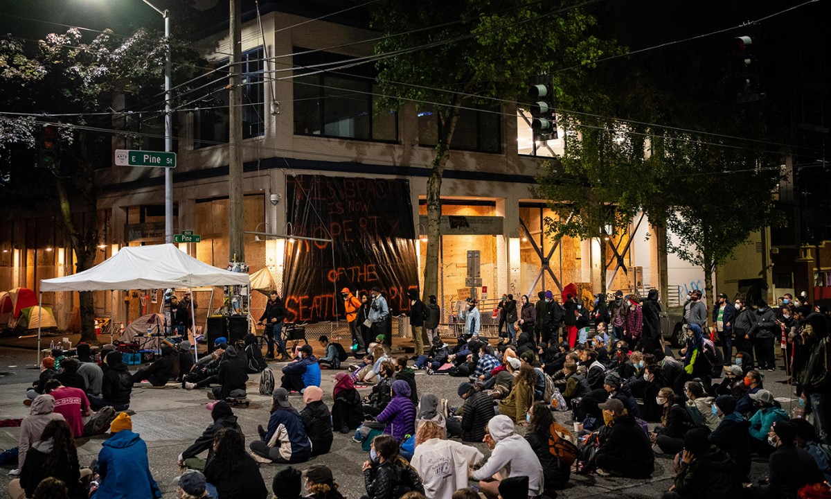 People sit in the street while watching a documentary film screening outside of the Seattle Police Departments East Precinct on June 9, 2020, in Seattle. Protests have continued in many parts of the city including inside City Hall and around the Seattle Police Departments East Precinct, an area that has earned the moniker "Capitol Hill Autonomous Zone," during ongoing Black Lives Matter protests in the wake of George Floyd's death. (Photo: David Ryder/Getty Images)