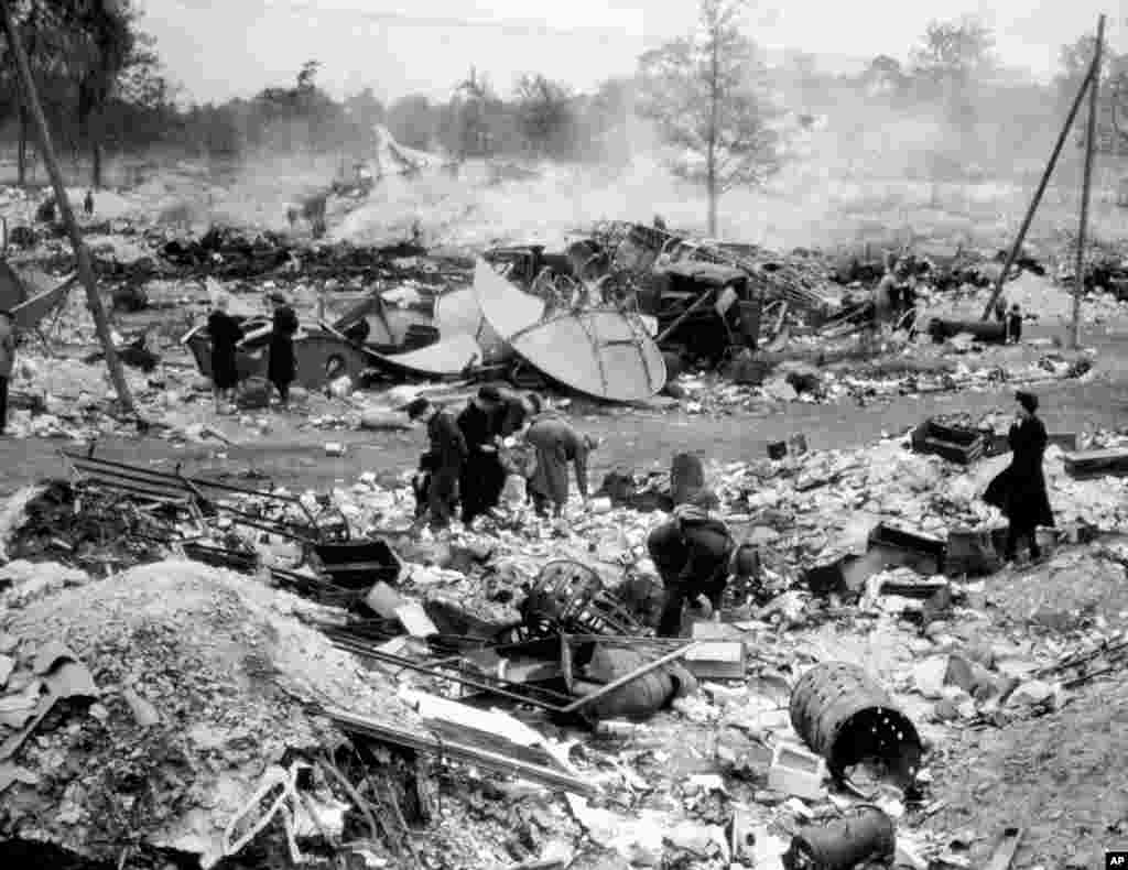 People forage for food and fuel for cooking fires in a dumping ground near a Berlin airport. The foragers were known as &ldquo;hamsters,&rdquo; a name coined in 1918 -- the last time Germany was devastated by war. &nbsp;