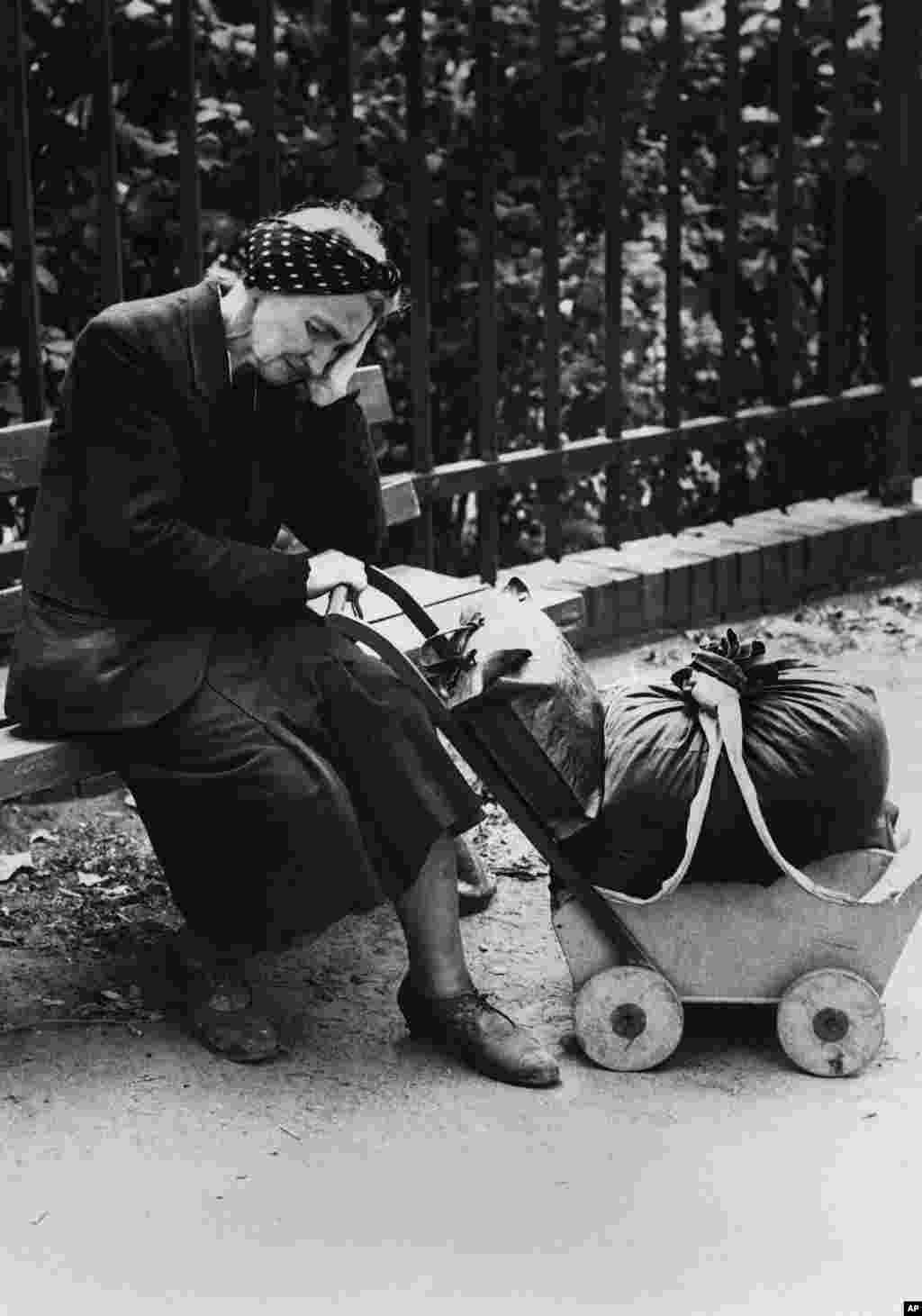 A woman left homeless by the war rests on a public bench. &nbsp; Russian journalist Vasily Grossman, who witnessed the fall of Berlin, described seeing in local faces &ldquo;not only personal suffering but also that of [citizens] of a destroyed country.&rdquo;