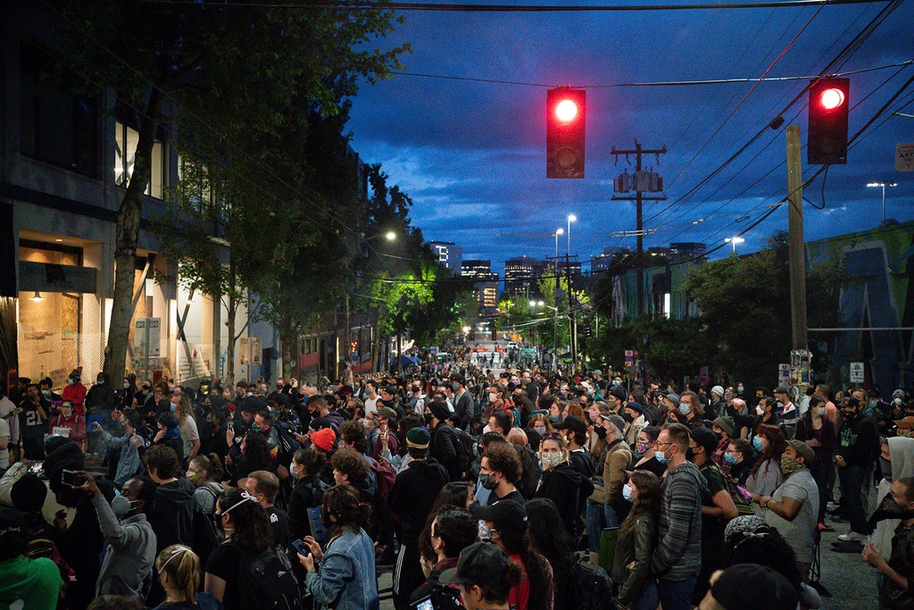 SEATTLE, WA - JUNE 10: People listen as a band plays a free show in front of the Seattle Police Departments East Precinct in the so-called "Capitol Hill Autonomous Zone" on June 10, 2020 in Seattle, Washington. The zone includes the blocks surrounding the Seattle Police Departments East Precinct, which was the site of violent clashes with Black Lives Matter protesters, who have continued to demonstrate in the wake of George Floyds death. (Photo by David Ryder/Getty Images)