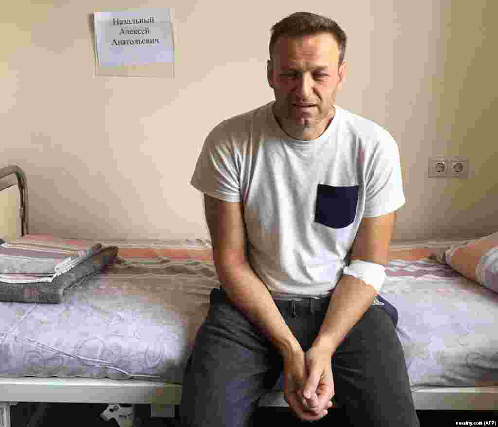 Navalny, his eyes red and puffy, sits on a hospital bed in Moscow on July 29, 2019, after feeling unwell in his Moscow cell while serving a prison term on charges of calling an unauthorized rally. He said he believed he'd been poisoned. Doctors attributed it to an &quot;acute allergic reaction.&quot;