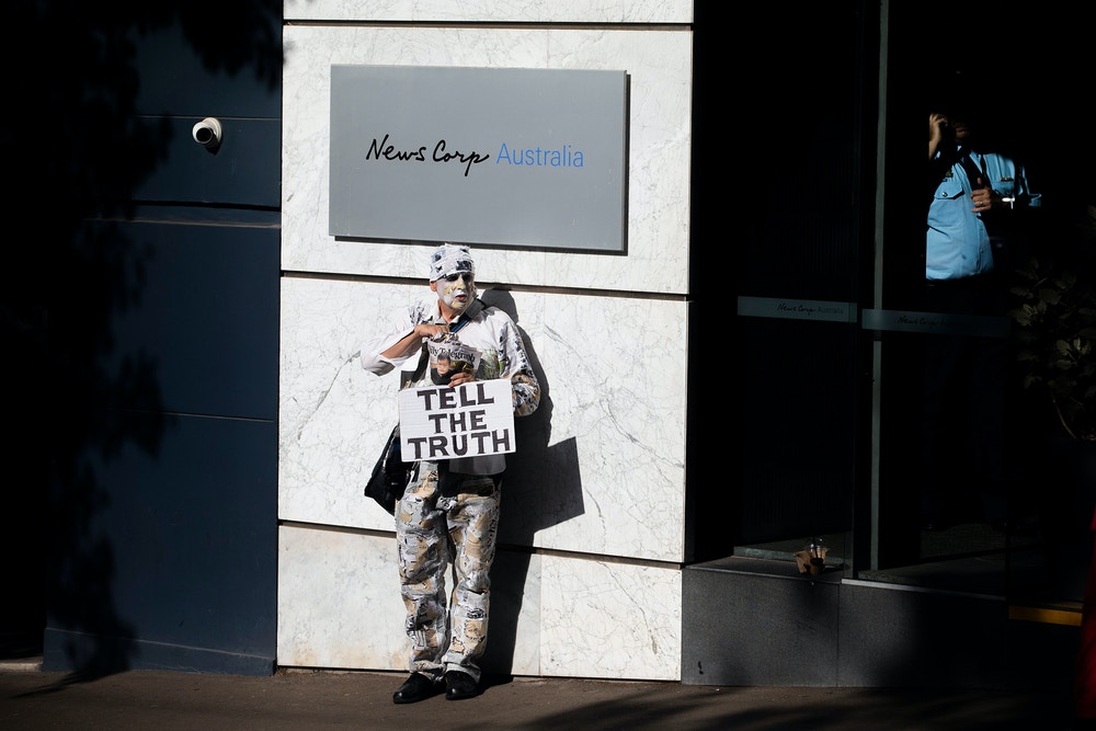 SYDNEY, AUSTRALIA - JANUARY 31: A protester is seen at the offices of News Corp Australia in Surry hills on January 31, 2020 in Sydney, Australia. The"lie-in" was organised to protest against what activists say are lies published across Rupert Murdoch's News Corp media outlets.  (Photo by Jenny Evans/Getty Images)