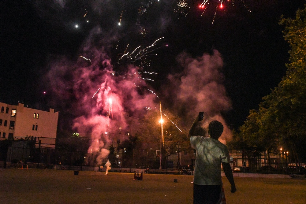 NEW YORK, NY - JUNE 24: A person records with a phone a fireworks display in an empty park on June 24, 2020 in the Brooklyn borough in New York City. According to New York City officials, complaints about fireworks have skyrocketed in recent weeks. (Photo by Stephanie Keith/Getty Images)