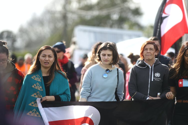 women with flags and banners protesting