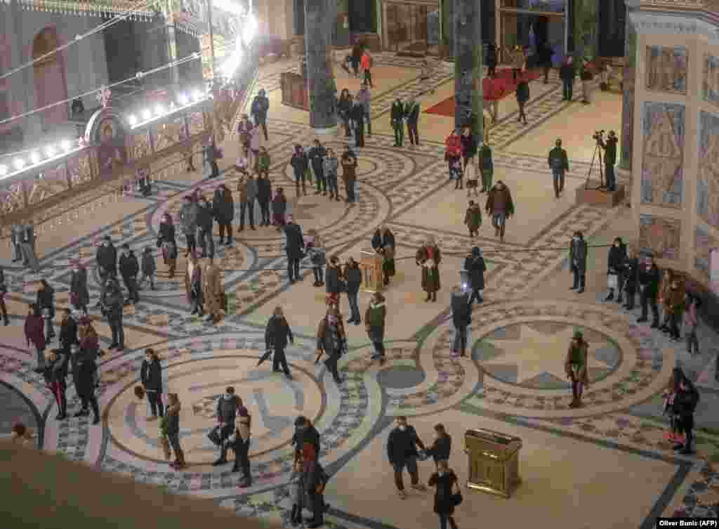 Orthodox Christians maintain social distancing inside Belgrade's St. Sava Church before the Christmas mass.&nbsp;