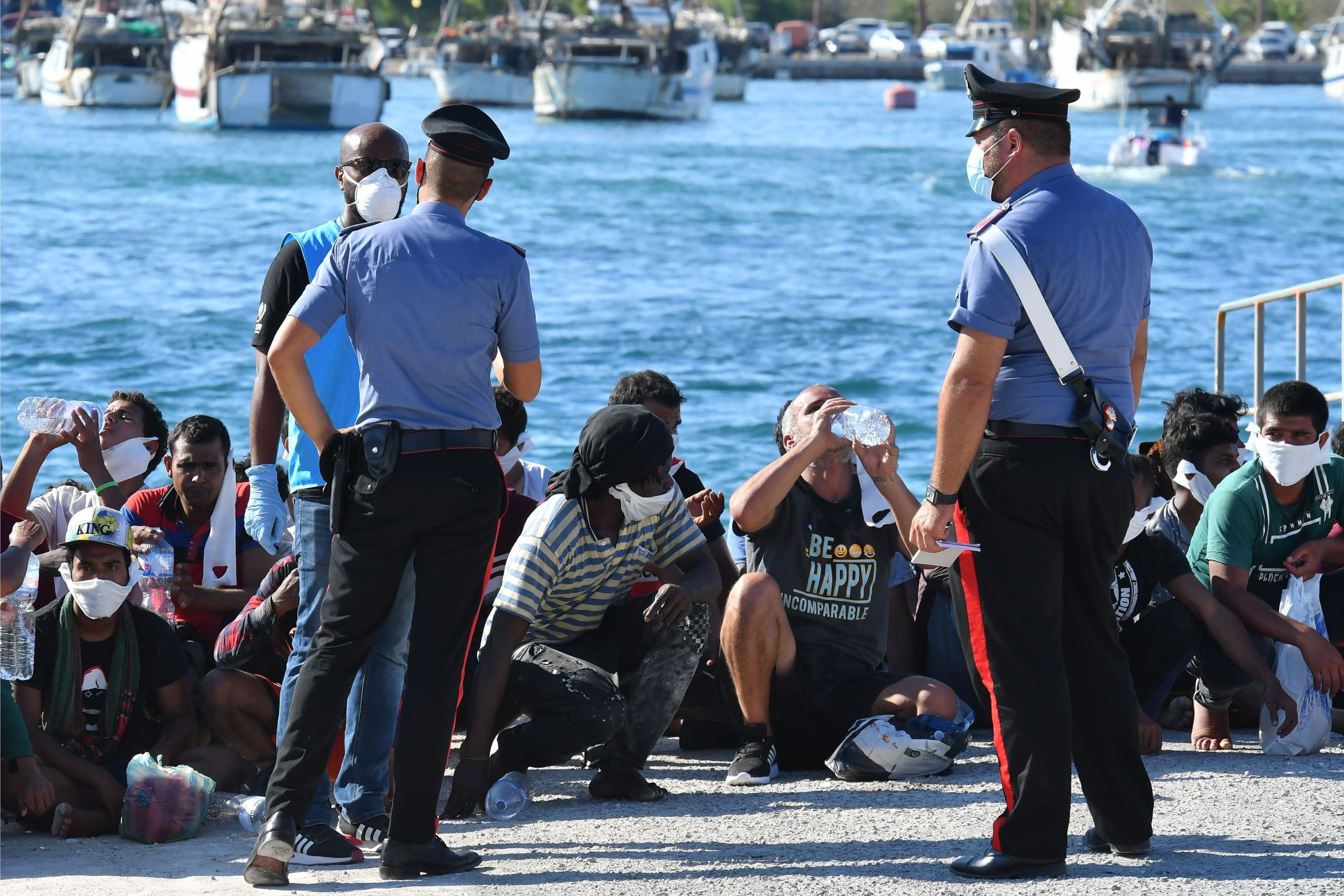 Migrants rescued by Italys' Guardia Costiera rests in the harbor of the Italian Pelagie Island of Lampedusa on July 29, 2020.