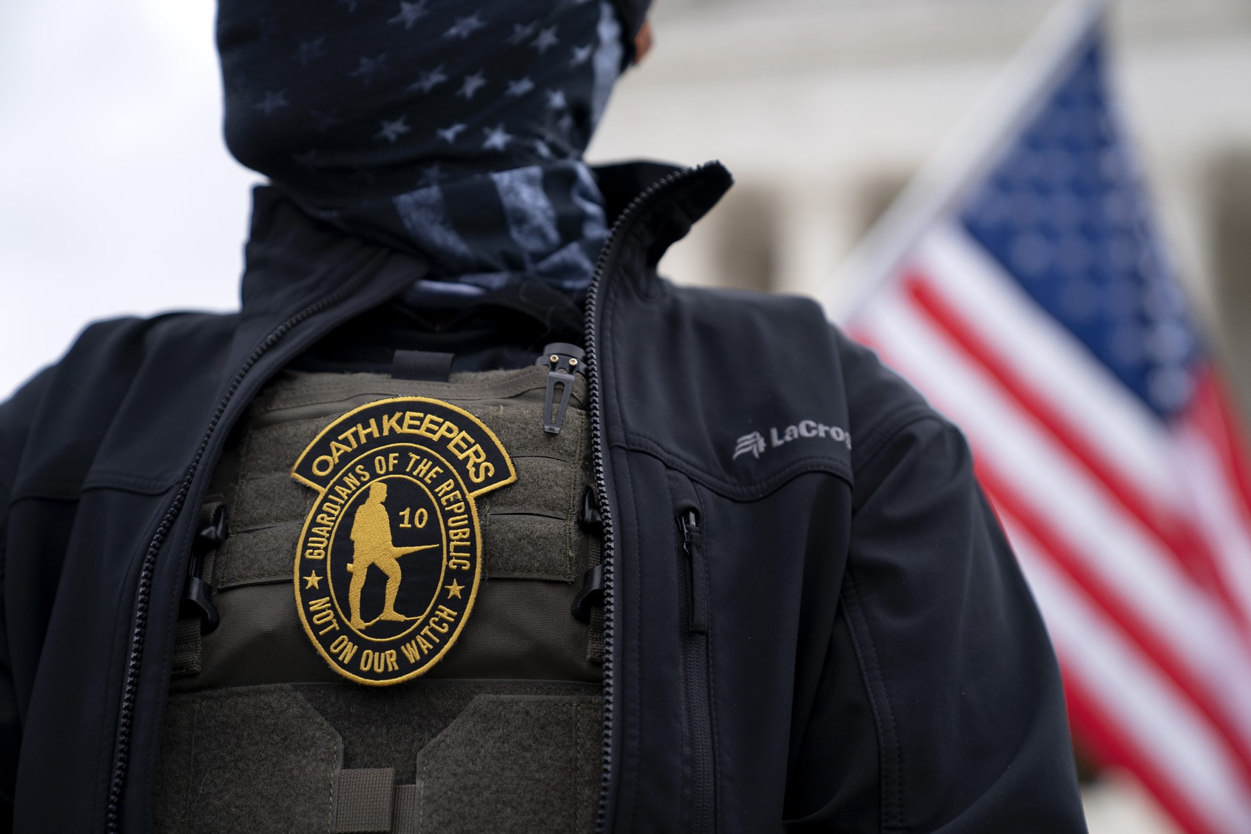 A demonstrator wears an Oath Keepers anti-government organization badge on a protective vest during a protest outside the Supreme Court in Washington, D.C., U.S., on Tuesday, Jan. 5, 2021. Republican lawmakers in Washington are fracturing over President Trump's futile effort to persuade Congress to overturn his re-election defeat, as his allies spar with conservatives who say the Constitution doesn't give them the power to override voters. Photographer: Stefani Reynolds/Bloomberg via Getty Images