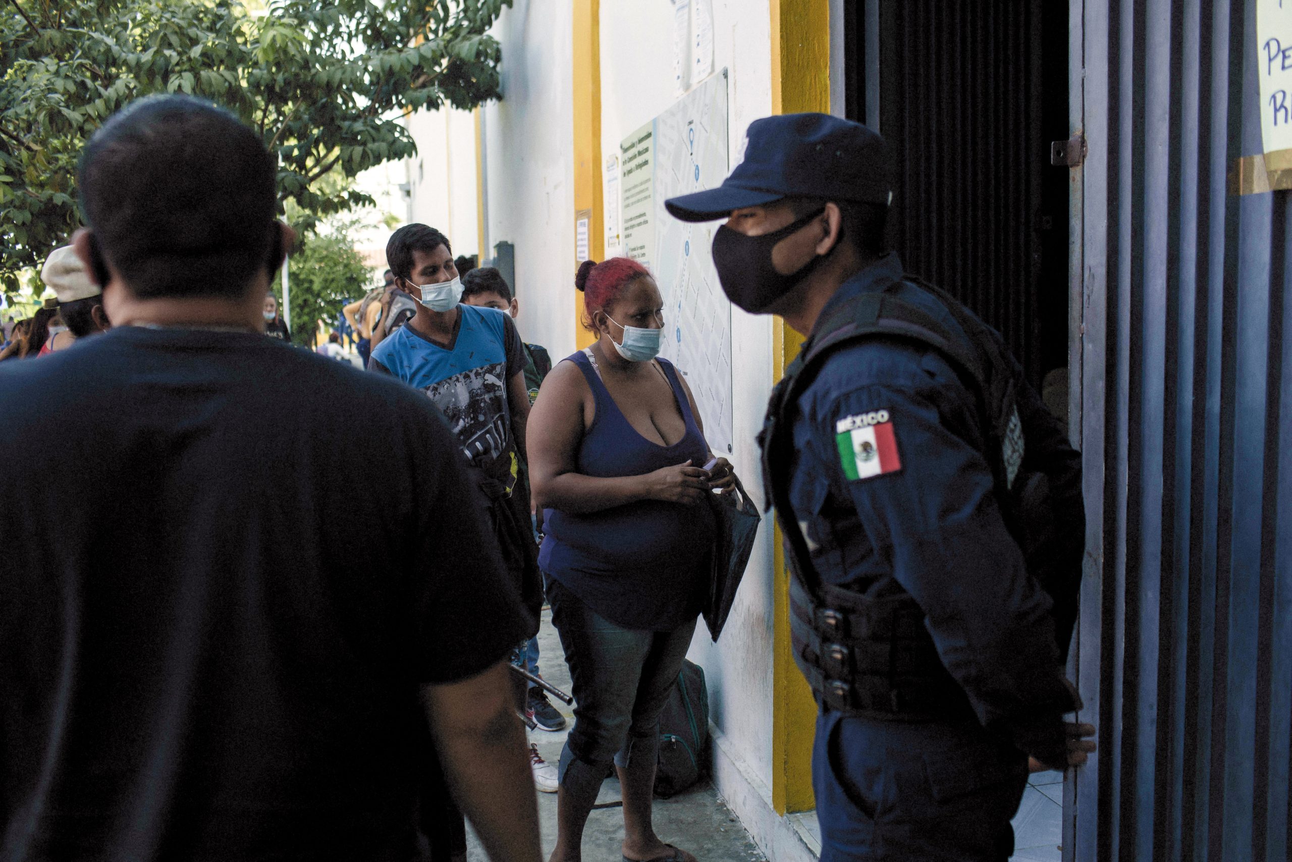 Refugees and asylum seekers stand in line to enter the Mexican Commission for Refugee Assistance (Comar) office in Tapachula, Chiapas state, Mexico, on Friday, Jan. 27, 2021. U.S. President Joe Biden and Mexican President Andres Manuel Lopez Obrador agreed to work together to stem the flow of irregular migration to their countries, the White House said. Photographer: Nicolo Filippo Rosso/Bloomberg via Getty Images